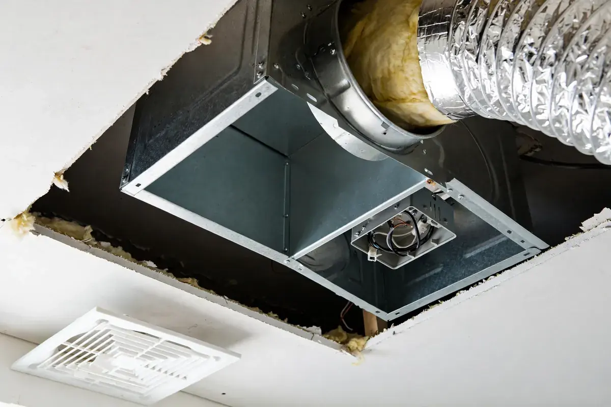 Opened ceiling exhaust fan housing with duct collar and wiring box