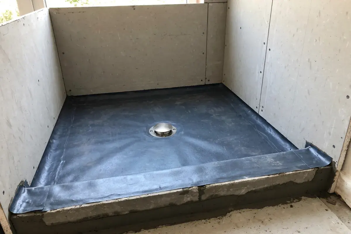 Low shower curb and drain with waterproof membrane in an alcove where a tub was removed